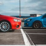 blue and red cars in parking lots