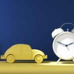 a toy car next to a clock on a table
